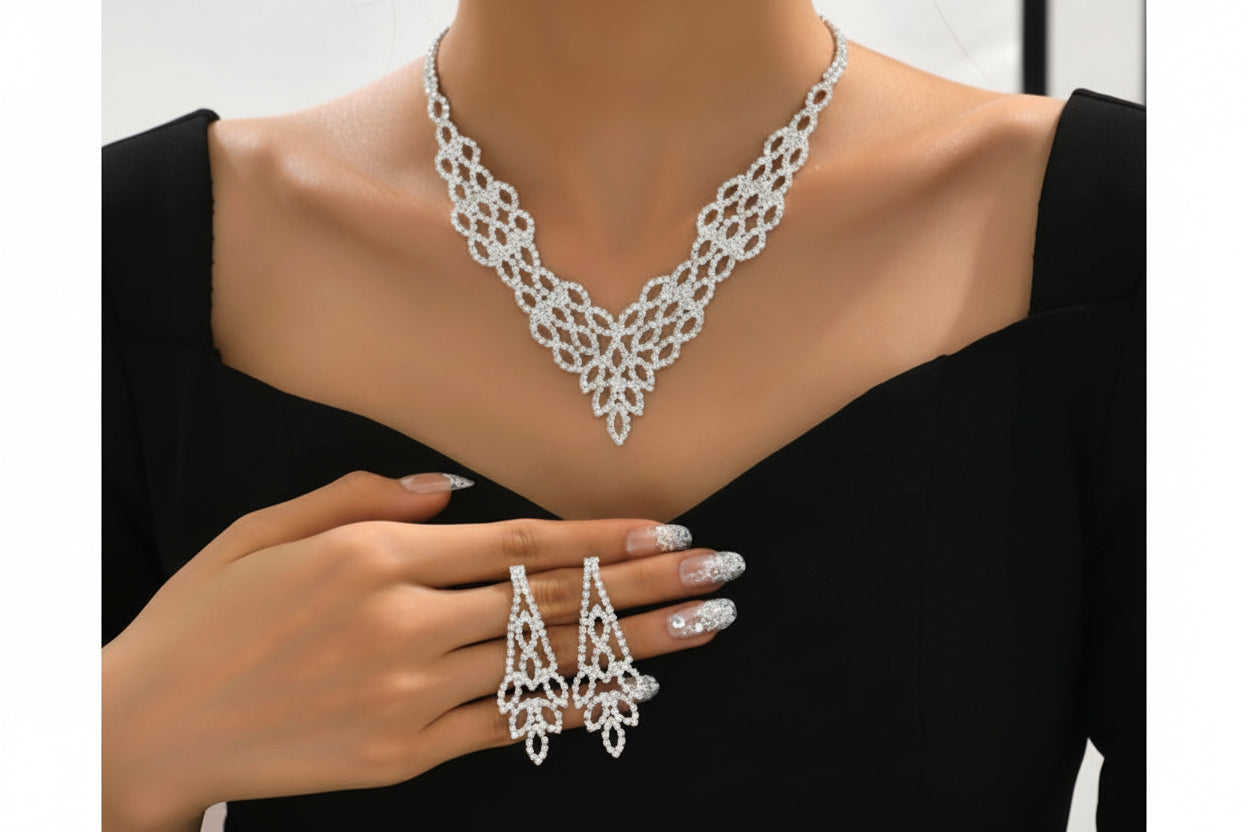 Silver necklace, earrings, and ring set on a mannequin with a black background