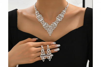 Silver necklace, earrings, and ring set on a mannequin with a black background