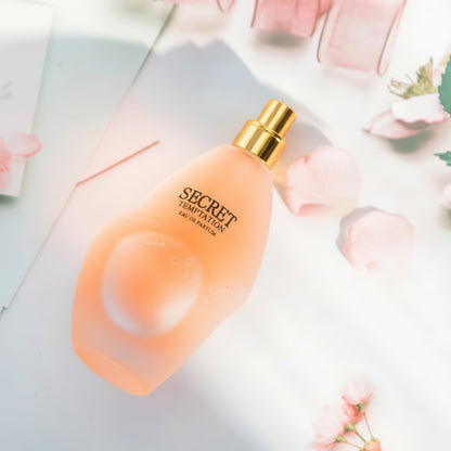 Perfume bottle labeled 'Secret' with a soft focus floral background