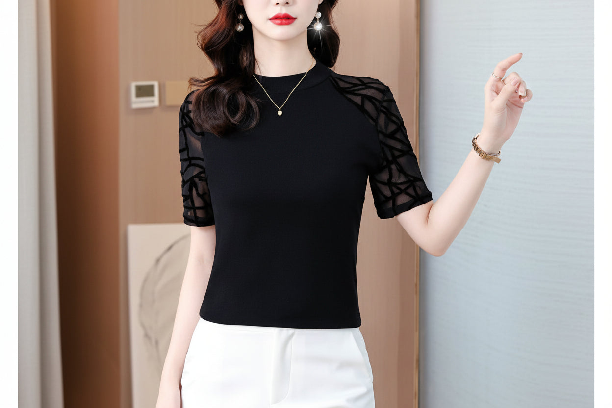 Woman wearing a black top with sheer sleeves against a neutral background