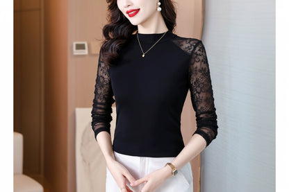 Woman wearing a black long-sleeve top with mesh panels against a neutral background