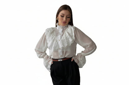 Woman wearing a white blouse with lace details on a white background
