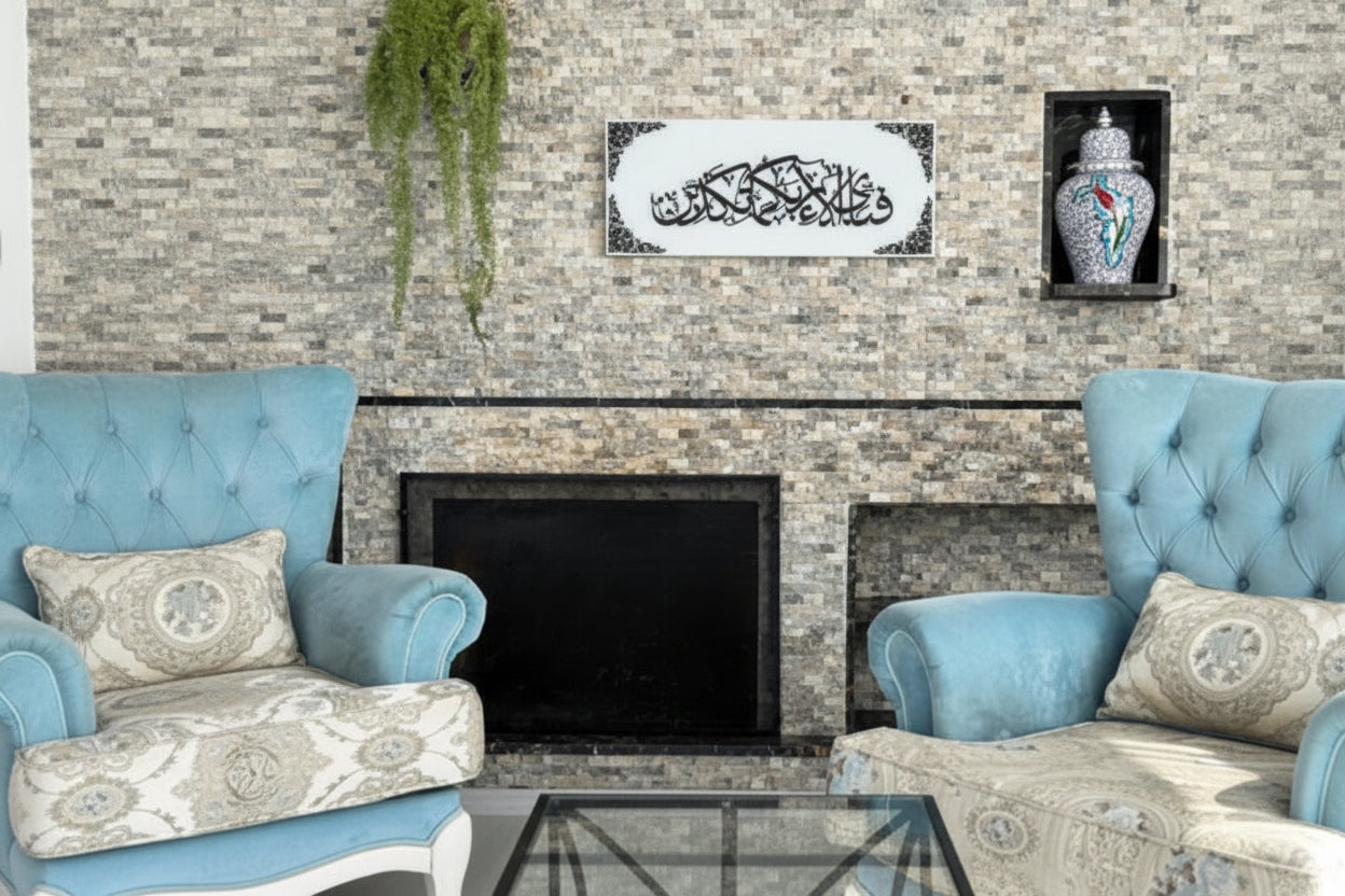 Living room with stone fireplace, blue armchairs, and decorative wall art.