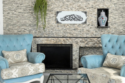 Living room with stone fireplace, blue armchairs, and decorative wall art.