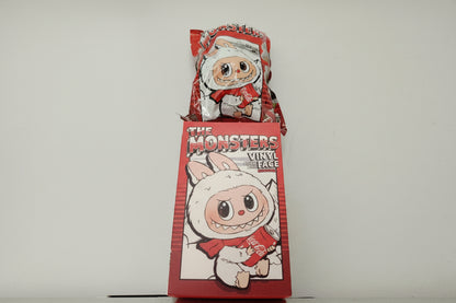 Two vinyl figures in red packaging with cartoon faces on a white background