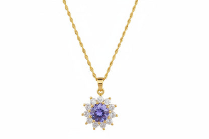 Gold necklace with a star-shaped diamond pendant on a white background