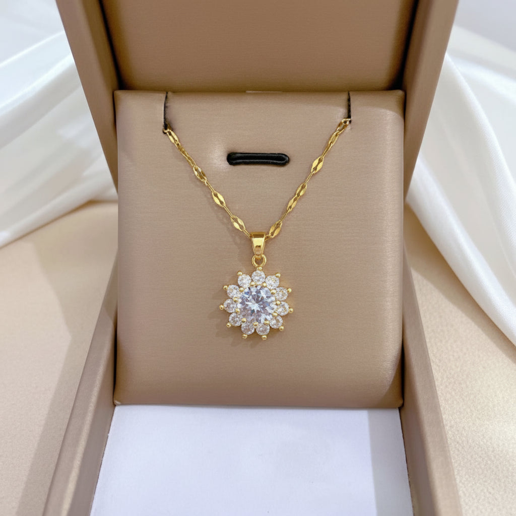Gold necklace with a diamond pendant in an open jewelry box