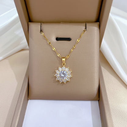 Gold necklace with a diamond pendant in an open jewelry box