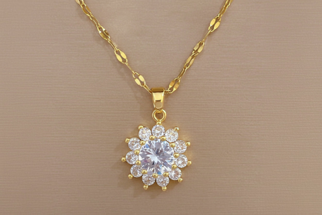Gold necklace with a diamond pendant on a beige background