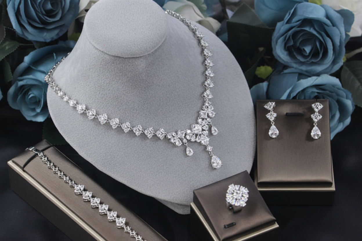 Jewelry set with necklace and earrings on a brown stand with blue flowers in the background