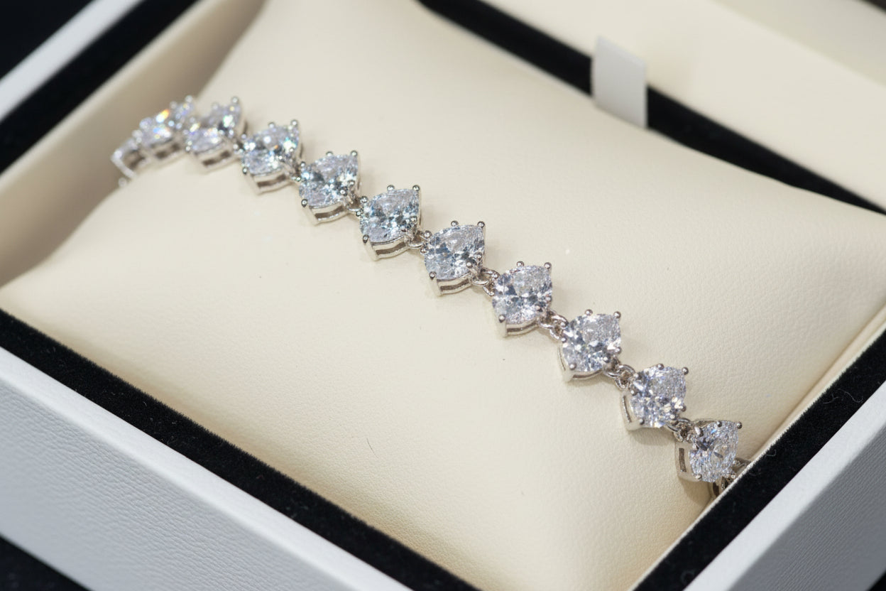 Silver bracelet with heart-shaped crystals on a dark surface