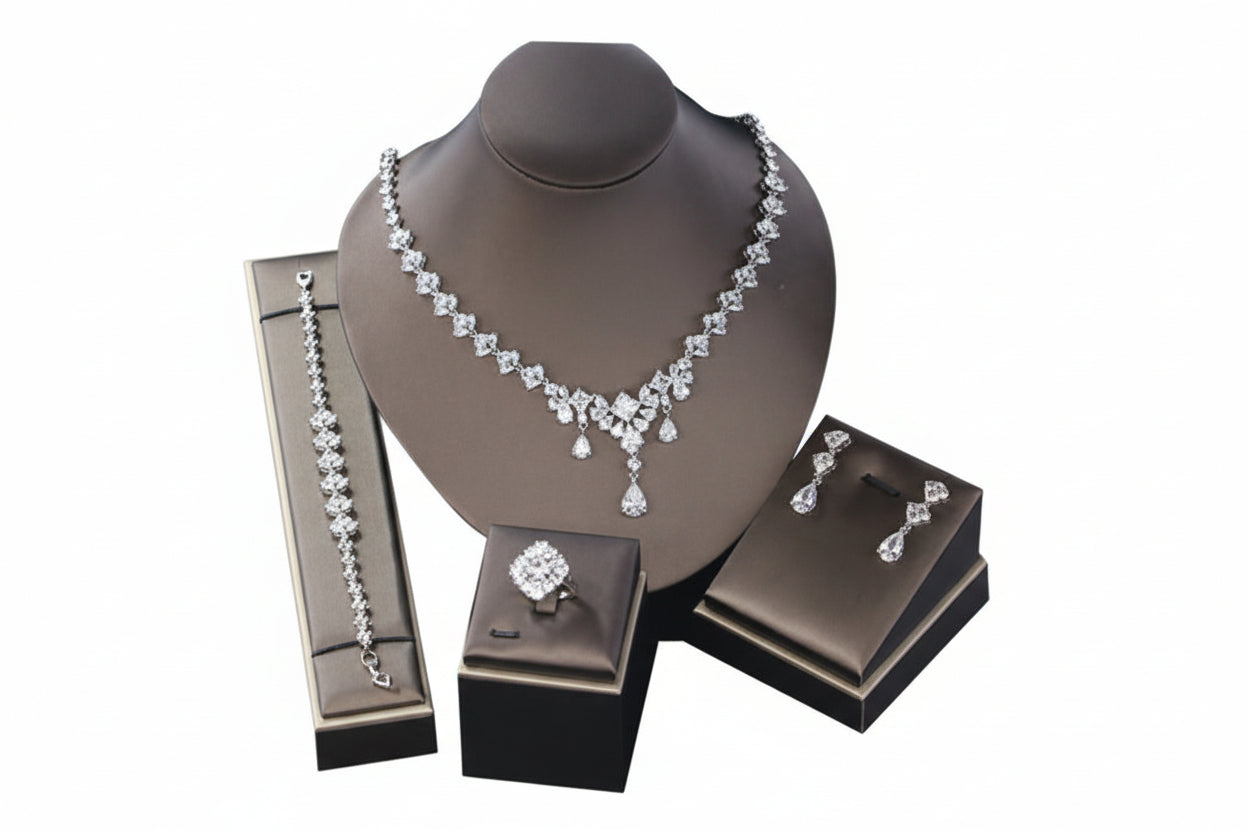 Jewelry set including necklace, earrings, and ring on a mannequin bust with branded boxes.