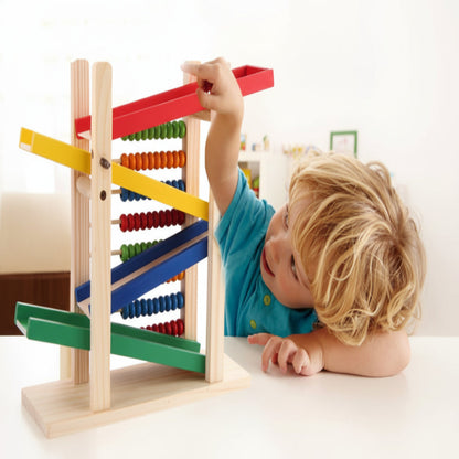 Child playing with a colorful wooden abacus on a white background