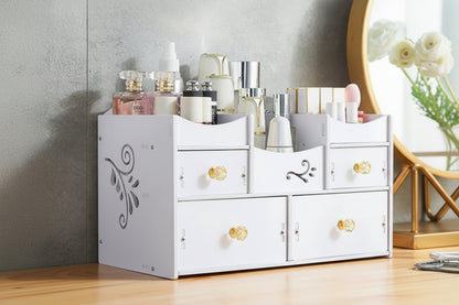 White cosmetic organizer with gold knobs holding various beauty products against a neutral wall.