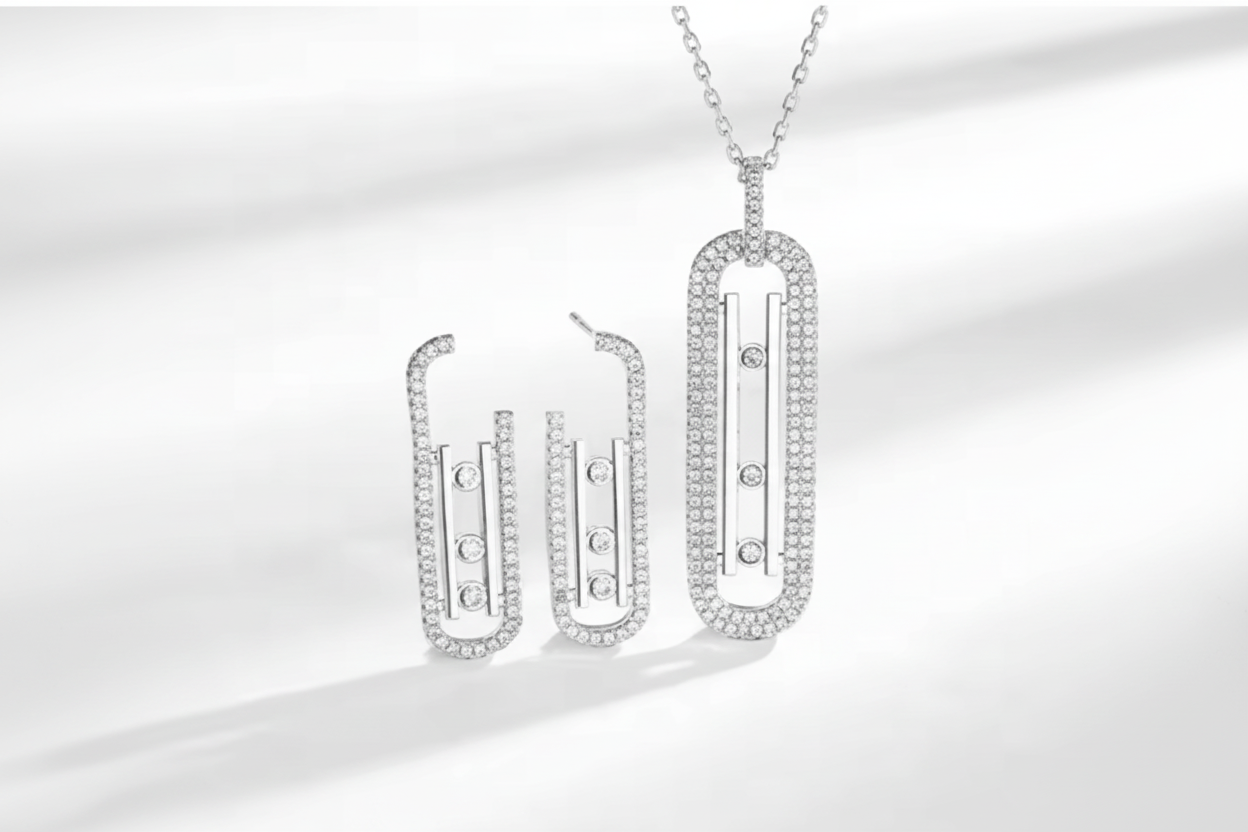 Silver necklace and earrings set on a white background