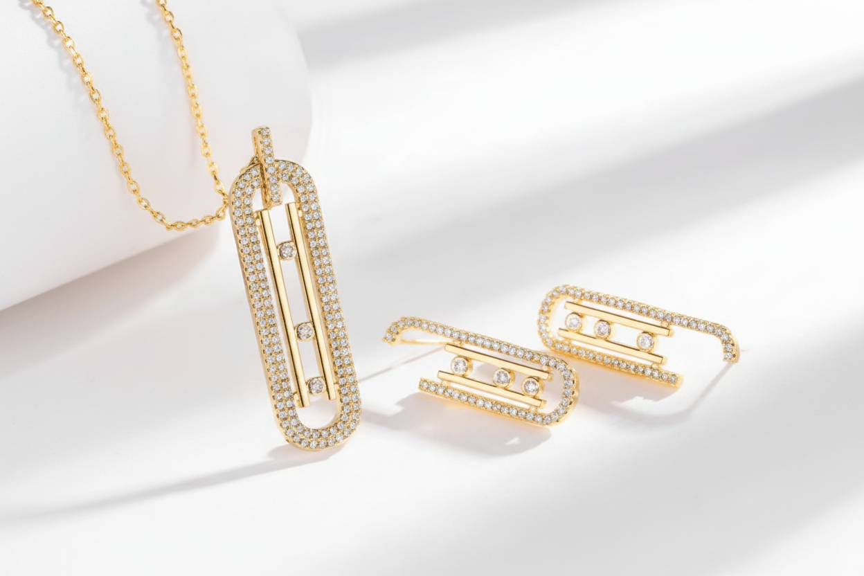 Gold necklace and bracelet set on a white fabric background